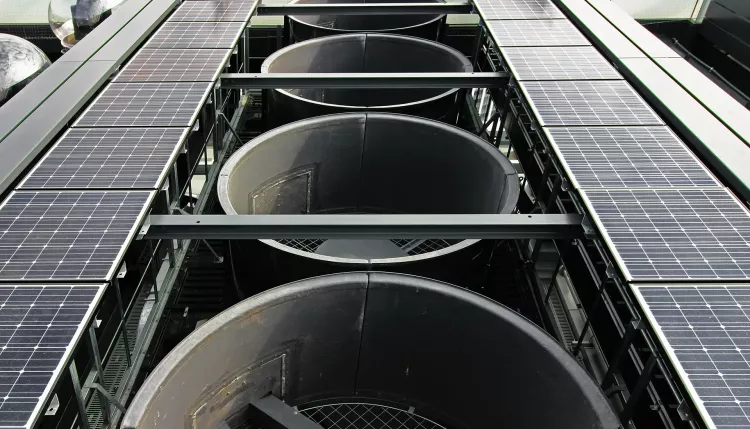 Outdoor equipment installed on the roof of a skyscraper with large exhaust vents, solar panels and live cameras